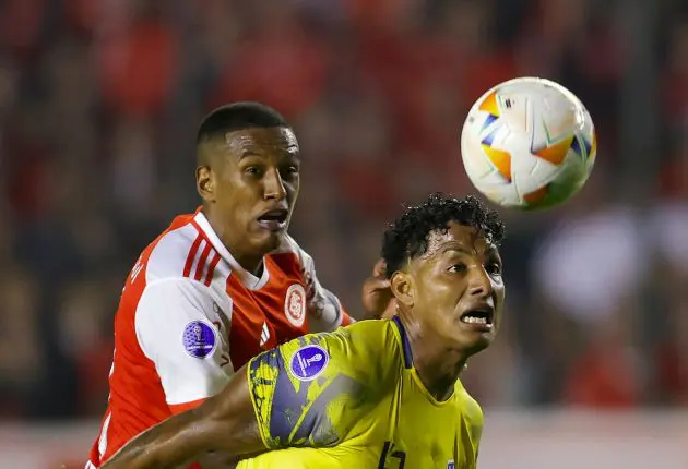 TOPSHOT - Internacional's defender Robert Renan (L) and Delfin's midfielder Jean Humanante (R) fight for the ball during the Copa Sudamericana group stage second leg football match between Brazil's Internacional and Ecuador's Delfin at the Alfredo Jaconi Stadium in Caxias do Sul, Rio Grande do Sul state, Brazil, on June 8, 2024. (Photo by SILVIO AVILA / AFP) (Photo by SILVIO AVILA/AFP via Getty Images)