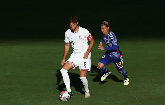 KANSAS CITY, KANSAS - JUNE 11: Tanner Tessmann #8 of the USA controls the ball as Ryotaro Araki #13 of Japan defends during the U23 match at Children's Mercy Park on June 11, 2024 in Kansas City, Kansas. (Photo by Jamie Squire/Getty Images)