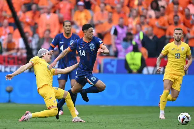 Romania's midfielder #10 Ianis Hagi fights for the ball with Netherlands' midfielder #14 Tijani Reijnders during the UEFA Euro 2024 round of 16 football match between Romania and the Netherlands at the Munich Football Arena in Munich on July 2, 2024. (Photo by MIGUEL MEDINA / AFP) (Photo by MIGUEL MEDINA/AFP via Getty Images)