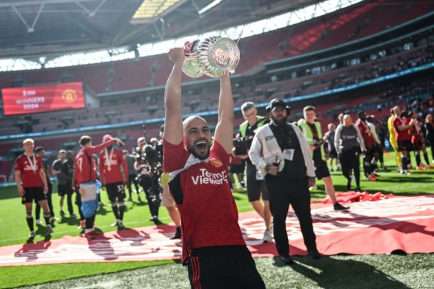 Manchester United midfielder Sofyan Amrabat celebrates with the trophy after winning at the end of the English FA Cup final football match between Manchester City and Manchester United at Wembley stadium, in London, on May 25, 2024. Manchester United wins 2 - 1 against Manchester City. (Photo by JUSTIN TALLIS / AFP) / NOT FOR MARKETING OR ADVERTISING USE / RESTRICTED TO EDITORIAL USE (Photo by JUSTIN TALLIS/AFP via Getty Images)