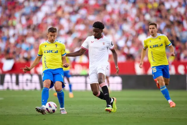 SEVILLE, SPAIN - MAY 15: Ruben Alcaraz of Cadiz CF competes for the ball with Lucien Agoume of Sevilla FC during the LaLiga EA Sports match between Sevilla FC and Cadiz CF at Estadio Ramon Sanchez Pizjuan on May 15, 2024 in Seville, Spain. (Photo by Fran Santiago/Getty Images)