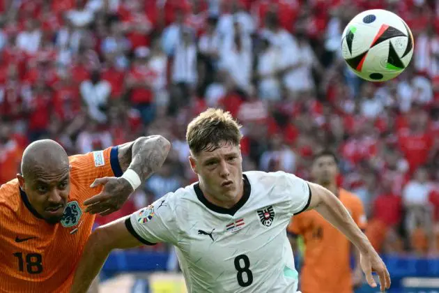 Netherlands' forward #18 Donyell Malen fights for the ball with Austria's midfielder #08 Alexander Prass during the UEFA Euro 2024 Group D football match between the Netherlands and Austria at the Olympiastadion in Berlin on June 25, 2024. (Photo by Christophe SIMON / AFP) (Photo by CHRISTOPHE SIMON/AFP via Getty Images)