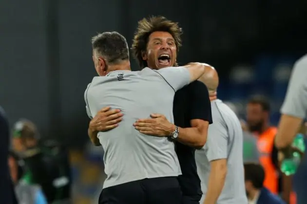 Napoli's Italian head coach Antonio Conte (R) celebrates with a staff member after Napoli's second goal during the Italian Serie A football match SSC Napoli against Bologna FC 1909, at the Diego Armando Maradona Stadium in Naples on August 25, 2024. (Photo by CARLO HERMANN / AFP) (Photo by CARLO HERMANN/AFP via Getty Images)