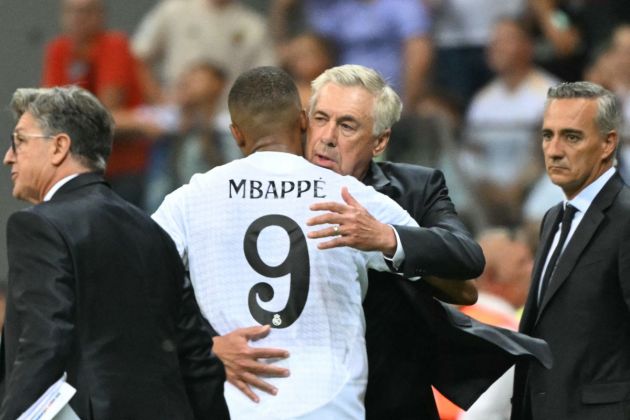 Real Madrid's French forward #09 Kylian Mbappe hugs Real Madrid's Italian coach Carlo Ancelotti during the UEFA Super Cup football match between Real Madrid and Atalanta BC in Warsaw, on August 14, 2024. (Photo by Sergei GAPON / AFP) (Photo by SERGEI GAPON/AFP via Getty Images)