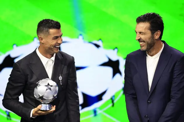 Portugal's national team player and Saudi Al-Nassr's forward Cristiano Ronaldo who is awarded the All-Time Goalscorer Award in the UEFA Champions League (L) and Italy's former goalkeeper Gianluigi Buffon who awarded the 2024 UEFA President's Award share a laugh on stage during the ceremony of the draw for the group stage of the 2024-2025 UEFA Champions League football tournament, at the Grimaldi Forum in Monaco on August 29, 2024. (Photo by Valery HACHE / AFP) (Photo by VALERY HACHE/AFP via Getty Images)