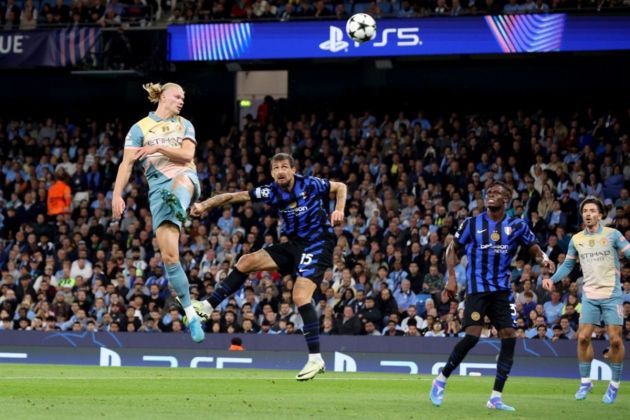 Erling Haaland (L) of Manchester City heads the ball during the UEFA Champions League match between Manchester City and Inter in Manchester, Britain, 18 September 2024. EPA-EFE/ADAM VAUGHAN