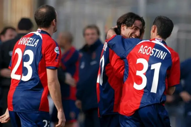 Forward Andrea Capone (C) pf Cagliari is congratulated by teammates Alessandro Agostini (R) and Antonio Langella after scoring against AC Siena during the Italian Serie A soccer match Cagliari vs AC Siena, which ended with a 2-2 draw on Sunday 11 February 2007. Italy's first division Serie A resumed on Sunday with spectators allowed into just five of the 10 matches. Milan's San Siro-Giuseppe Meazza stadium was open only to AC Milan's 37,000 season ticket holders. The rest took place behind closed doors - the result of a tough anti-hooligan plan approved by the government in response to the death of policeman Filippo Raciti during rioting at a Serie A match last week. EPA/ROSAS