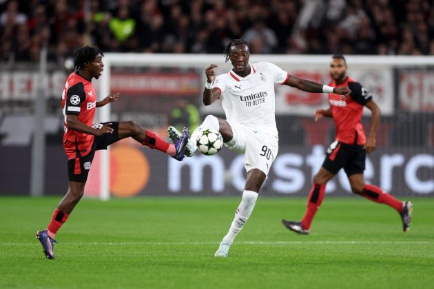 LEVERKUSEN, GERMANY - OCTOBER 01: Tammy Abraham of AC Milan is challenged by Jeremie Frimpong of Bayer 04 Leverkusen during the UEFA Champions League 2024/25 League Phase MD2 match between Bayer 04 Leverkusen and AC Milan at BayArena on October 01, 2024 in Leverkusen, Germany. (Photo by Lars Baron/Getty Images)