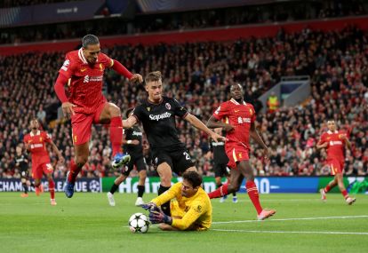 LIVERPOOL, ENGLAND - OCTOBER 02: Virgil van Dijk of Liverpool jumps over Alisson Becker of Liverpool as he makes a save against Thijs Dallinga of Bologna during the UEFA Champions League 2024/25 League Phase MD2 match between Liverpool FC and Bologna FC 1909 at Anfield on October 02, 2024 in Liverpool, England. (Photo by Carl Recine/Getty Images)