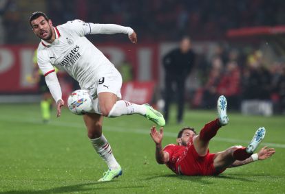 MONZA, ITALY - NOVEMBER 02: Theo Hernandez of AC Milan is challenged by Pedro Pereira of AC Monza during the Serie A match between AC Monza and AC Milan at U-Power Stadium on November 02, 2024 in Monza, Italy. (Photo by Marco Luzzani/Getty Images)