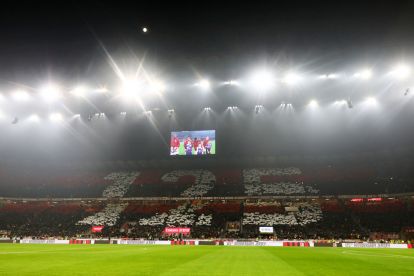 MILAN, ITALY - DECEMBER 15: General view inside the stadium as fans hold placards for AC Milan's 125th Anniversary prior to the Serie A match between AC Milan and Genoa at Stadio Giuseppe Meazza on December 15, 2024 in Milan, Italy. (Photo by Marco Luzzani/Getty Images)