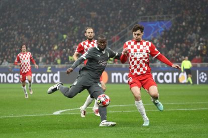 MILAN, ITALY - JANUARY 22: Yunus Musah of AC Milan shoots whilst under pressure from Ladislav Krejci of Girona FC during the UEFA Champions League 2024/25 League Phase MD7 match between AC Milan and Girona FC at Stadio San Siro on January 22, 2025 in Milan, Italy. (Photo by Marco Luzzani/Getty Images)