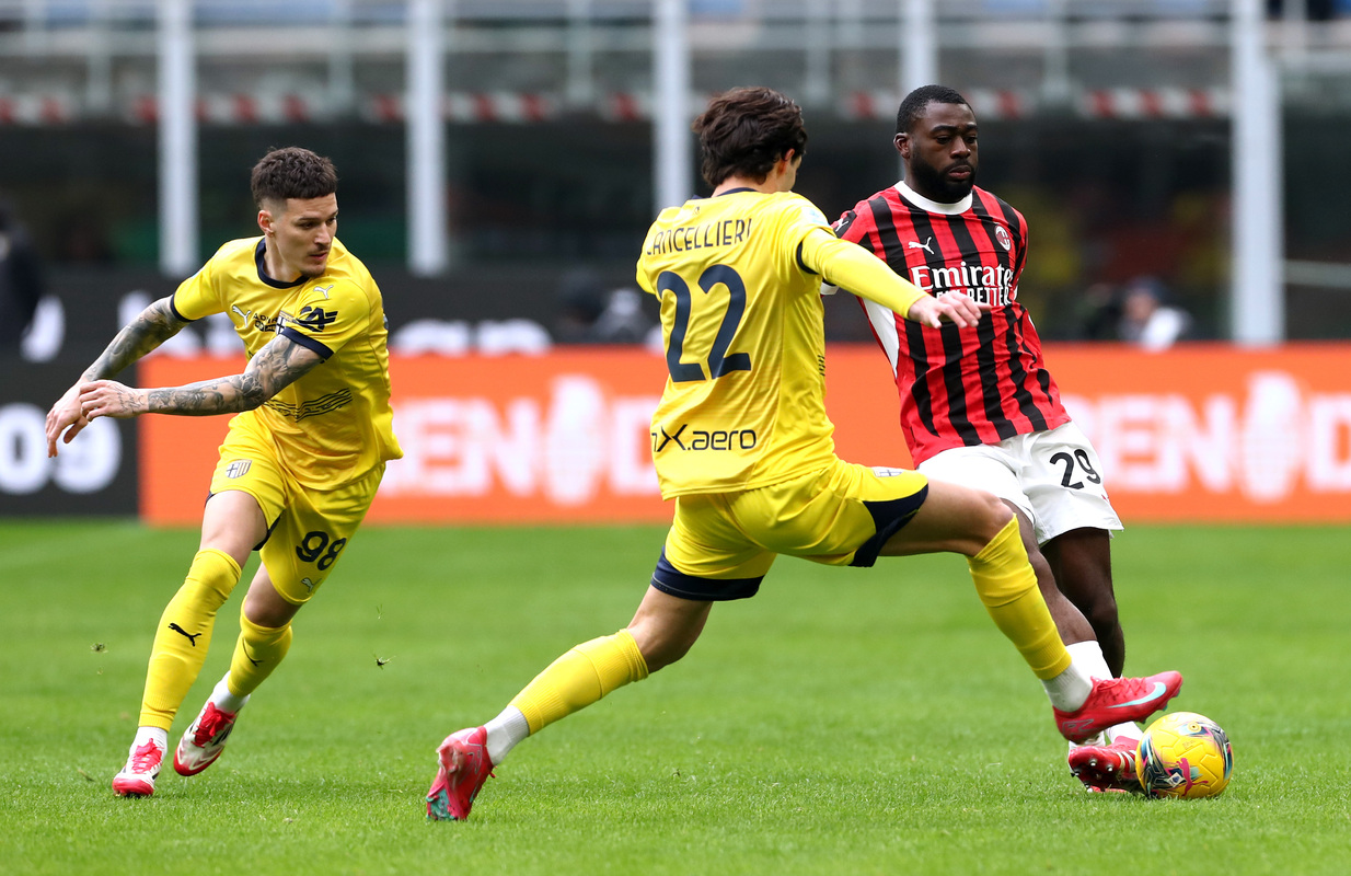 Youssouf Fofana of AC Milan is challenged by Matteo Cancellieri of Parma Calcio during the Serie A match between AC Milan and Parma at Stadio Giuseppe Meazza on January 26, 2025 in Milan, Italy. (Photo by Marco Luzzani/Getty Images)