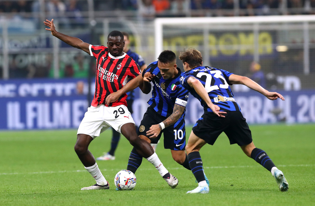 Youssouf Fofana of AC Milan is challenged by Lautaro Martinez of FC Internazionale during the Serie A match between FC Internazionale and AC Milan at Stadio Giuseppe Meazza on September 22, 2024 in Milan, Italy. (Photo by Marco Luzzani/Getty Images)