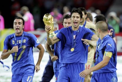 BERLIN - JULY 09: Scorer of the matchwinning penalty, Fabio Grosso (c) of Italy,celebrates with the world cup trophy after the FIFA World Cup Germany 2006 Final match between Italy and France at the Olympic Stadium on July 9, 2006 in Berlin, Germany. (Photo by Andreas Rentz/Bongarts/Getty Images)