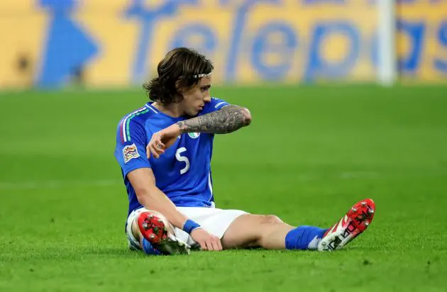 MILAN, ITALY - MARCH 20: Riccardo Calafiori of Italy goes down with an injury during the UEFA Nations League quarterfinal leg one match between Italy and Germany at Stadio San Siro on March 20, 2025 in Milan, Italy. (Photo by Alex Grimm/Getty Images)