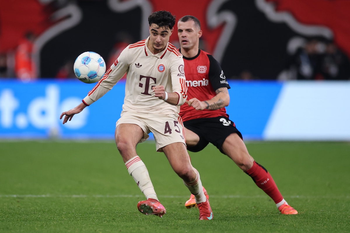 LEVERKUSEN, GERMANY - FEBRUARY 15: Aleksandar Pavlovic  is challenged by Granit Xhaka of Bayer 04 Leverkusen during the Bundesliga match between Bayer 04 Leverkusen and FC Bayern München at BayArena on February 15, 2025 in Leverkusen, Germany. (Photo by Alex Grimm/Getty Images)