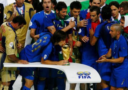 BERLIN - JULY 09: Andrea Pirlo of Italy kisses the World Cup trophy following his team's victory in a penalty shootout at the end of the FIFA World Cup Germany 2006 Final match between Italy and France at the Olympic Stadium on July 9, 2006 in Berlin, Germany. (Photo by Clive Mason/Getty Images)