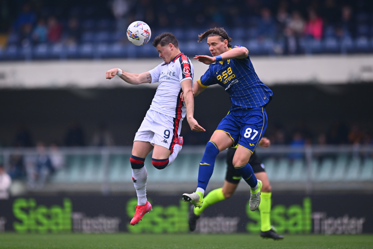 VERONA, ITALY - APRIL 13: Vitinha of Genoa and Daniele Ghilardi of Hellas Verona compete for a header during the Serie A match between Verona and Genoa at Stadio Marcantonio Bentegodi on April 13, 2025 in Verona, Italy. (Photo by Alessandro Sabattini/Getty Images)