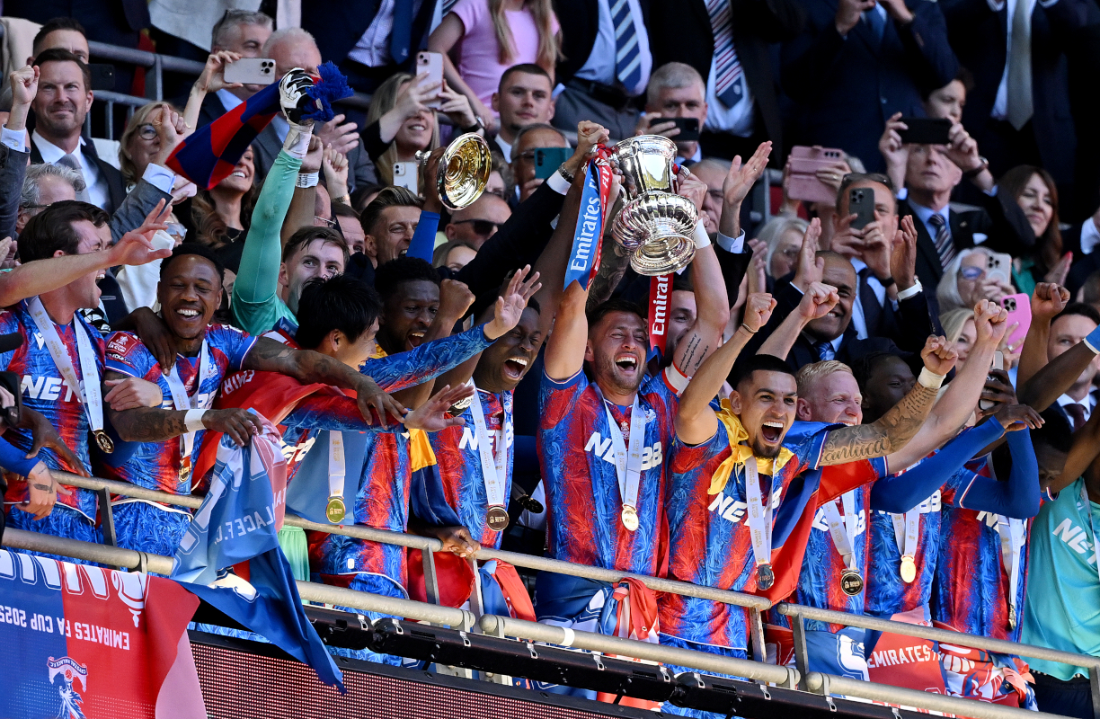 LONDON, ENGLAND - MAY 17: Marc Guehi and Joel Ward of Crystal Palace lift the FA Cup trophy after their team's victory in the Emirates FA Cup Final match between Crystal Palace and Manchester City at Wembley Stadium on May 17, 2025 in London, England. (Photo by Mike Hewitt/Getty Images)