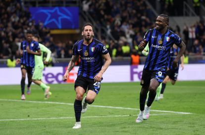 MILAN, ITALY - MAY 06: Hakan Calhanoglu of FC Internazionale (L) celebrates scoring his team's second goal with teammate Marcus Thuram (R) during the UEFA Champions League 2024/25 Semi Final Second Leg match between FC Internazionale Milano and FC Barcelona at Giuseppe Meazza Stadium on May 06, 2025 in Milan, Italy. (Photo by Carl Recine/Getty Images)
