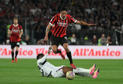 ROME, ITALY - MAY 14: Tijjani Reijnders of AC Milan evades a tackle from Jhon Lucumi of Bologna during the Coppa Italia Final match between AC Milan and Bologna at Stadio Olimpico on May 14, 2025 in Rome, Italy. (Photo by Marco Rosi/Getty Images)