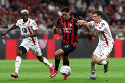 MILAN, ITALY - MAY 24: Tijjani Reijnders of AC Milan runs with the ball whilst under pressure from Alessandro Bianco and Jean-Daniel Akpa Akpro of Monza during the Serie A match between AC Milan and Monza at Stadio Giuseppe Meazza on May 24, 2025 in Milan, Italy. (Photo by Marco Luzzani/Getty Images)