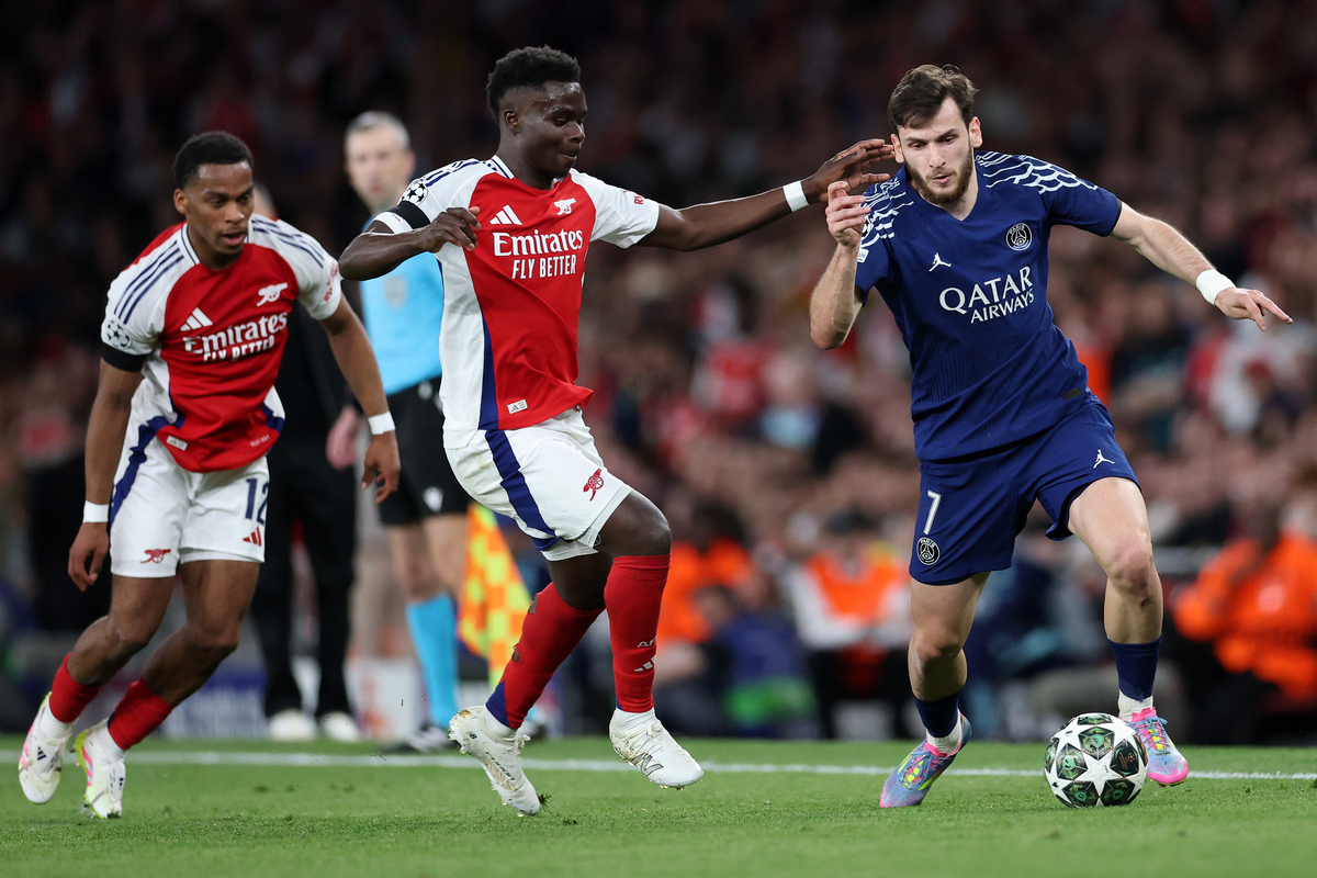 LONDON, ENGLAND - APRIL 29: Khvicha Kvaratskhelia of Paris Saint-Germain challenged by Bukayo Saka of Arsenal during the UEFA Champions League 2024/25 Semi Final First Leg match between Arsenal FC and Paris Saint-Germain at Emirates Stadium on April 29, 2025 in London, England. (Photo by Michael Steele/Getty Images)