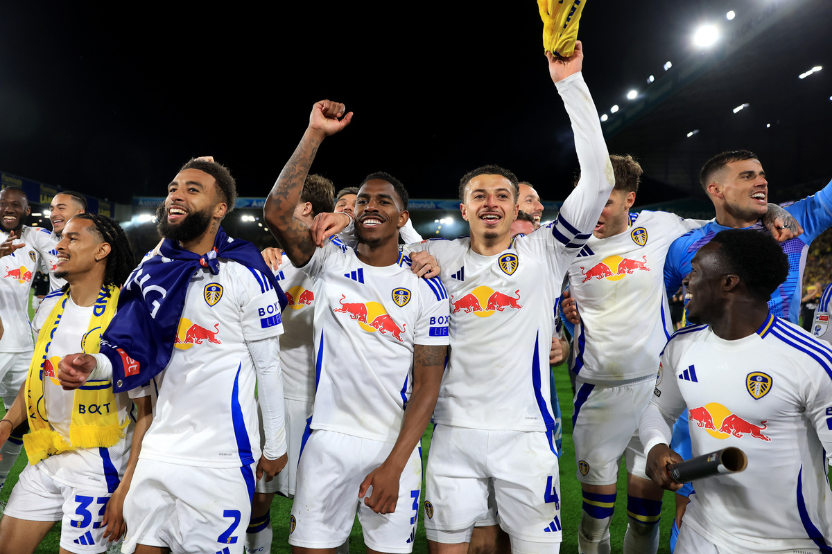 LEEDS, ENGLAND - APRIL 28: Isaac Schmidt, Jayden Bogle, Junior Firpo and Ethan Ampadu of Leeds United celebrate promotion to the Premier League at the end of the Sky Bet Championship match between Leeds United FC and Bristol City FC at Elland Road on April 28, 2025 in Leeds, England. (Photo by Carl Recine/Getty Images)