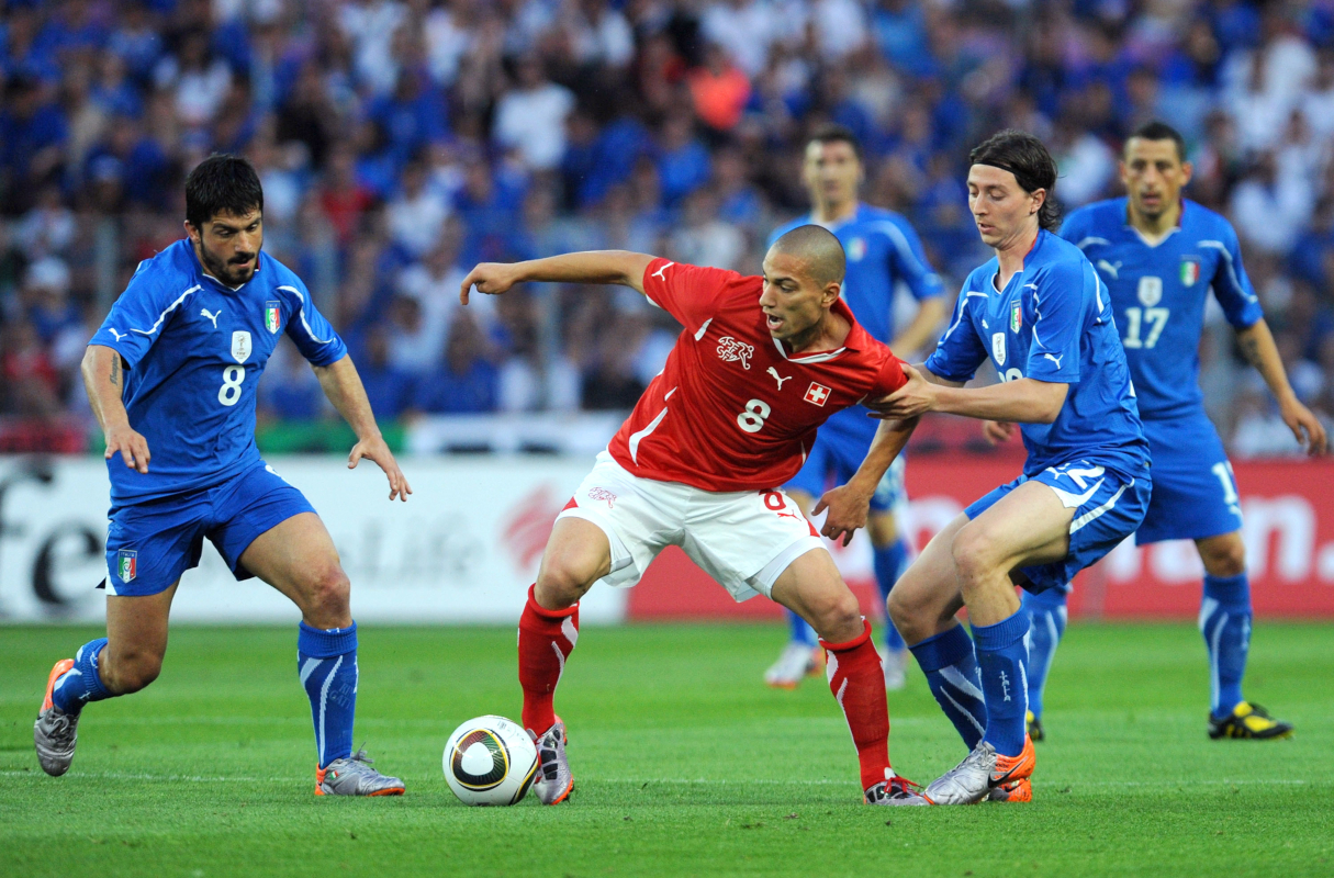 GENEVA - JUNE 05:  Gokhan Inler (C) of Switzerland is challenged by Gennaro Gattuso (L) and Riccardo Montolivo of Italy during the international friendly match between Switzerland and Italy at Stade de Geneve ahead of the FIFA World Cup 2010 in South Africa on June 5, 2010 in Geneva, Switzerland.  (Photo by Valerio Pennicino/Getty Images)