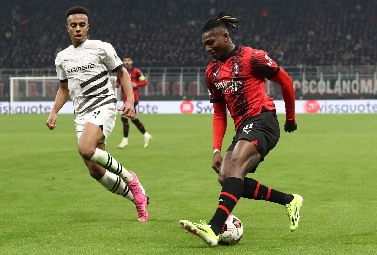 Rafael Leao of AC Milan battles for possession with Guela Doue of Stade Rennais FC during the UEFA Europa League 2023/24 Knockout Round Play-offs First Leg match between AC Milan and Stade Rennais FC at Stadio Giuseppe Meazza on February 15, 2024 in Milan, Italy. (Photo by Marco Luzzani/Getty Images)