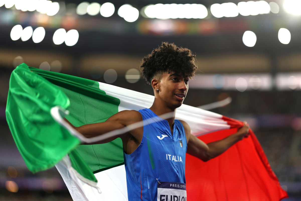 PARIS, FRANCE - AUGUST 06: Mattia Furlani of Team Italy celebrates winning the bronze medal after competing in the Men's Long Jump final on day eleven of the Olympic Games Paris 2024 at Stade de France on August 06, 2024 in Paris, France. (Photo by Cameron Spencer/Getty Images)