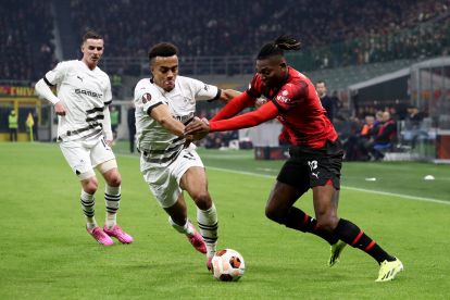 MILAN, ITALY - FEBRUARY 15: Rafael Leao of AC Milan battles for possession with Guela Doue of Stade Rennais during the UEFA Europa League 2023/24 Knockout Round Play-offs First Leg match between AC Milan and Stade Rennais FC at Stadio Giuseppe Meazza on February 15, 2024 in Milan, Italy. (Photo by Marco Luzzani/Getty Images)