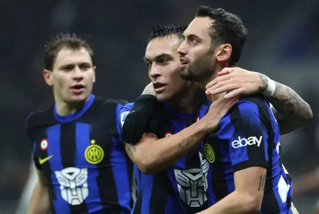 MILAN, ITALY - DECEMBER 09: Hakan Calhanoglu of FC Internazionale celebrates with teammate Lautaro Martinez after scoring their team's first goal during the Serie A TIM match between FC Internazionale and Udinese Calcio at Stadio Giuseppe Meazza on December 09, 2023 in Milan, Italy. (Photo by Marco Luzzani/Getty Images)