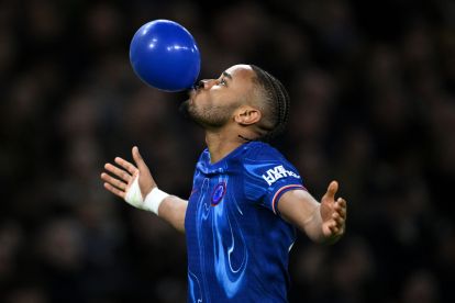 LONDON, ENGLAND - FEBRUARY 25: Christopher Nkunku of Chelsea celebrates scoring his team's first goal by blowing up a blue balloon during the Premier League match between Chelsea FC and Southampton FC at Stamford Bridge on February 25, 2025 in London, England. (Photo by Justin Setterfield/Getty Images)