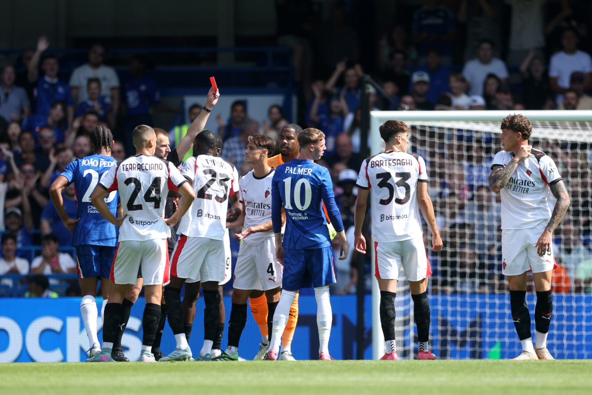 London, England - August 10: AC Milan's Andrei Coubis introduces a red card from the referee in a pre-season friendly match between Chelsea and AC Milan at Stamford Bridge in London, England on August 10, 2025. (Photo by Richard Pelham/Getty Images)