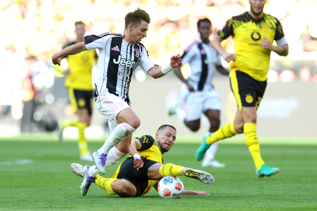 DORTMUND, GERMANY - AUGUST 10: Waldemar Anton of Borussia Dortmund battles for possession with Francisco Conceicao of Juventus during the pre-season friendly match between Borussia Dortmund and Juventus FC at Signal Iduna Park on August 10, 2025 in Dortmund, Germany. (Photo by Lars Baron/Getty Images)