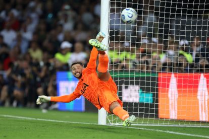 UDINE, ITALY - AUGUST 13: Guglielmo Vicario of Tottenham Hotspur fails to save a penalty kick from Goncalo Ramos of Paris Saint-Germain (not pictured) during the UEFA Super Cup 2025 match between Paris Saint-Germain and Tottenham Hotspur at Stadio Friuli on August 13, 2025 in Udine, Italy. (Photo by Claudio Villa/Getty Images)