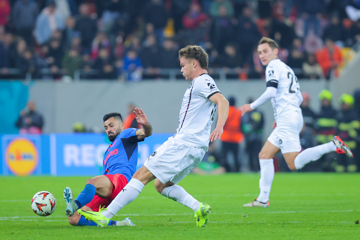 BUCHAREST, ROMANIA - NOVEMBER 07: Valentin Cretu (L) of FCSB battles for the ball with Oliver Sorensen (R) of FC Midtjylland during the UEFA Europa League 2024/25 League Phase MD4 match between Fotbal Club FCSB and FC Midtjylland at National Arena Stadium on November 07, 2024 in Bucharest, Romania. (Photo by Vasile Mihai-Antonio/Getty Images)