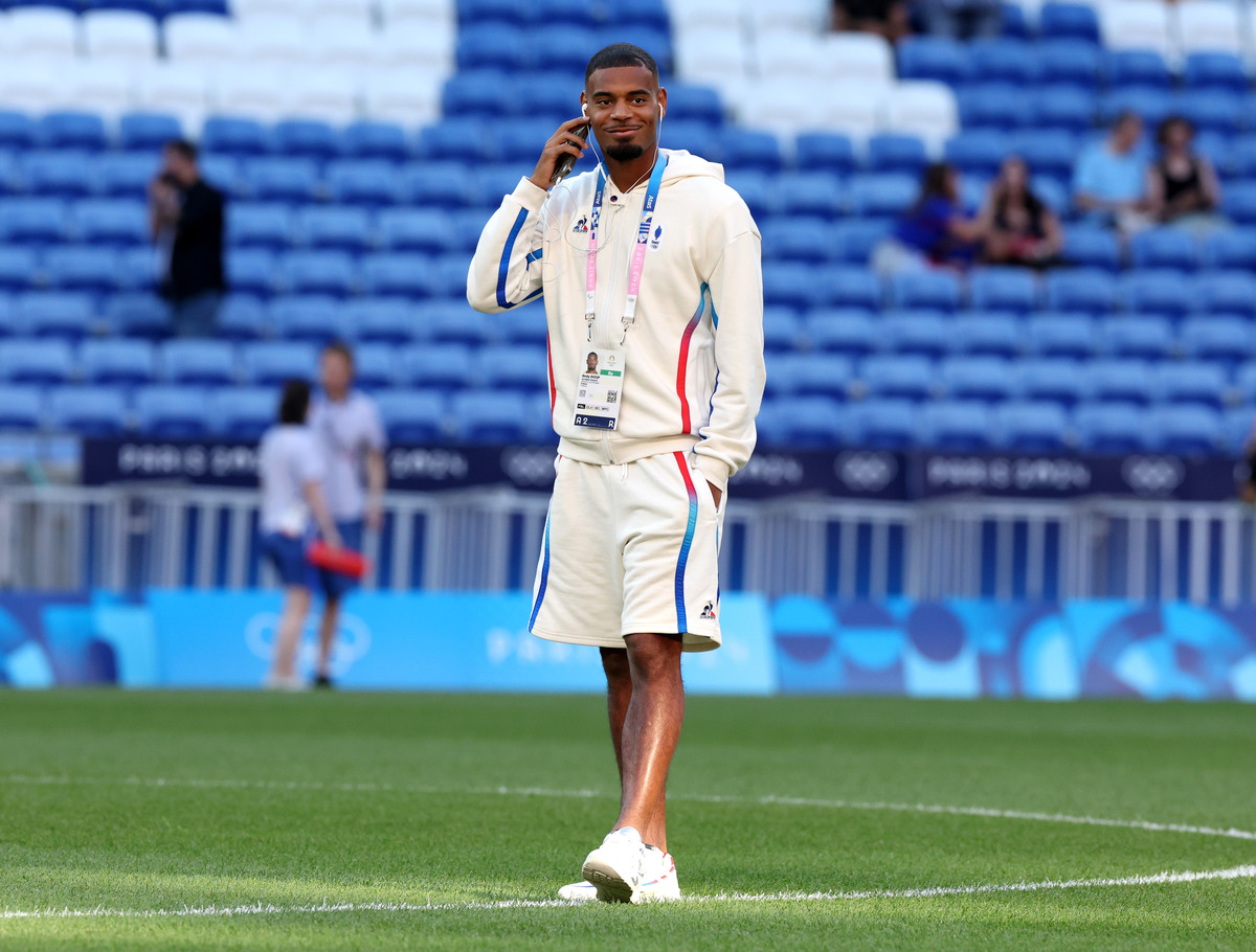 Andy Diouf inspecting the pitch