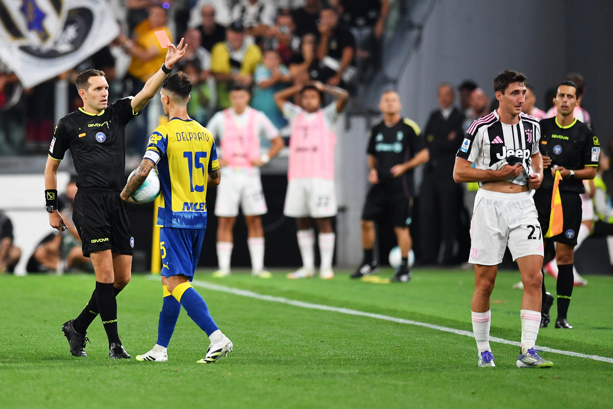 TURIN, ITALY - AUGUST 24: Andrea Cambiaso of Juventus is shown a red card by referee Matteo Marcenaro during the Serie A match between Juventus FC and Parma Calcio 1913 at on August 24, 2025 in Turin, Italy. (Photo by Valerio Pennicino/Getty Images)