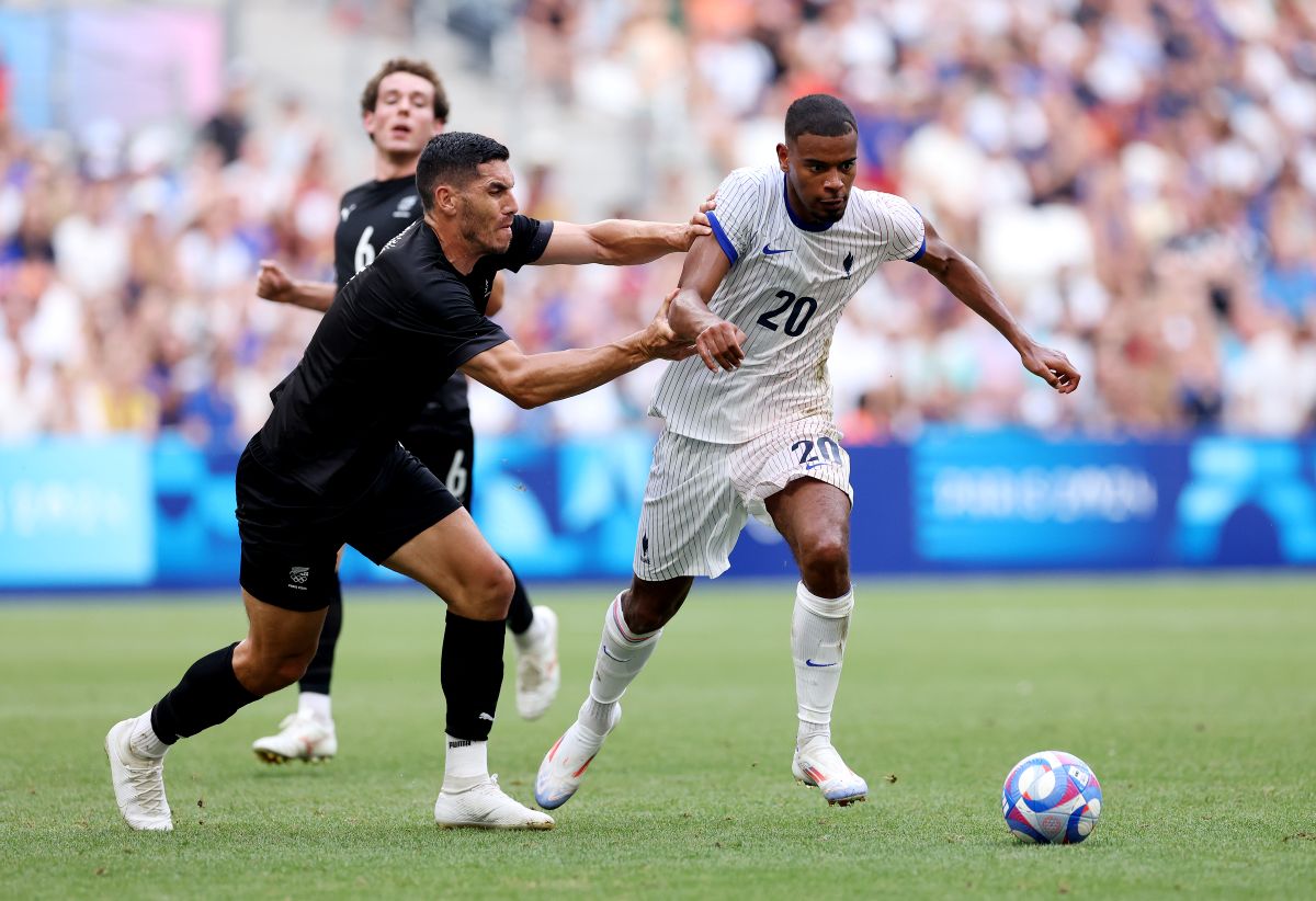 MARSEILLE, FRANCE - JULY 30: Andy Diouf #20 of Team France and Michael Boxall #2 of Team New Zealand battle for the ball during the Men's group A match between New Zealand and France during the Olympic Games Paris 2024 at Stade de Marseille on July 30, 2024 in Marseille, France. (Photo by Alex Livesey/Getty Images)