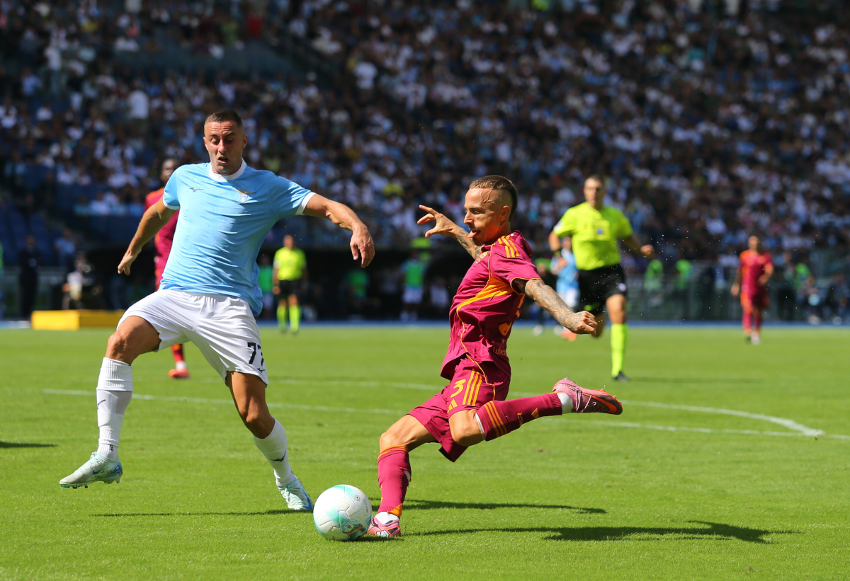 ROME, ITALY - SEPTEMBER 21: Angelino of AS Roma shoots while put under pressure by Adam Marusic of Lazio during the Serie A match between SS Lazio and AS Roma at Stadio Olimpico on September 21, 2025 in Rome, Italy. (Photo by Paolo Bruno/Getty Images)