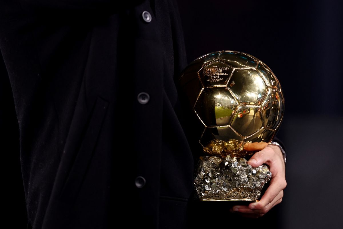 MANCHESTER, ENGLAND - NOVEMBER 23: Rodri of Manchester City holds his ballon d'or award prior to the Premier League match between Manchester City FC and Tottenham Hotspur FC at Etihad Stadium on November 23, 2024 in Manchester, England. (Photo by Naomi Baker/Getty Images)