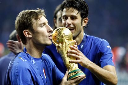 BERLIN - JULY 09: Francesco Totti (L) of Italy and teammate Fabio Grosso, celebrate with the world cup trophy, following the FIFA World Cup Germany 2006 Final match between Italy and France at the Olympic Stadium on July 9, 2006 in Berlin, Germany. (Photo by Andreas Rentz/Bongarts/Getty Images)
