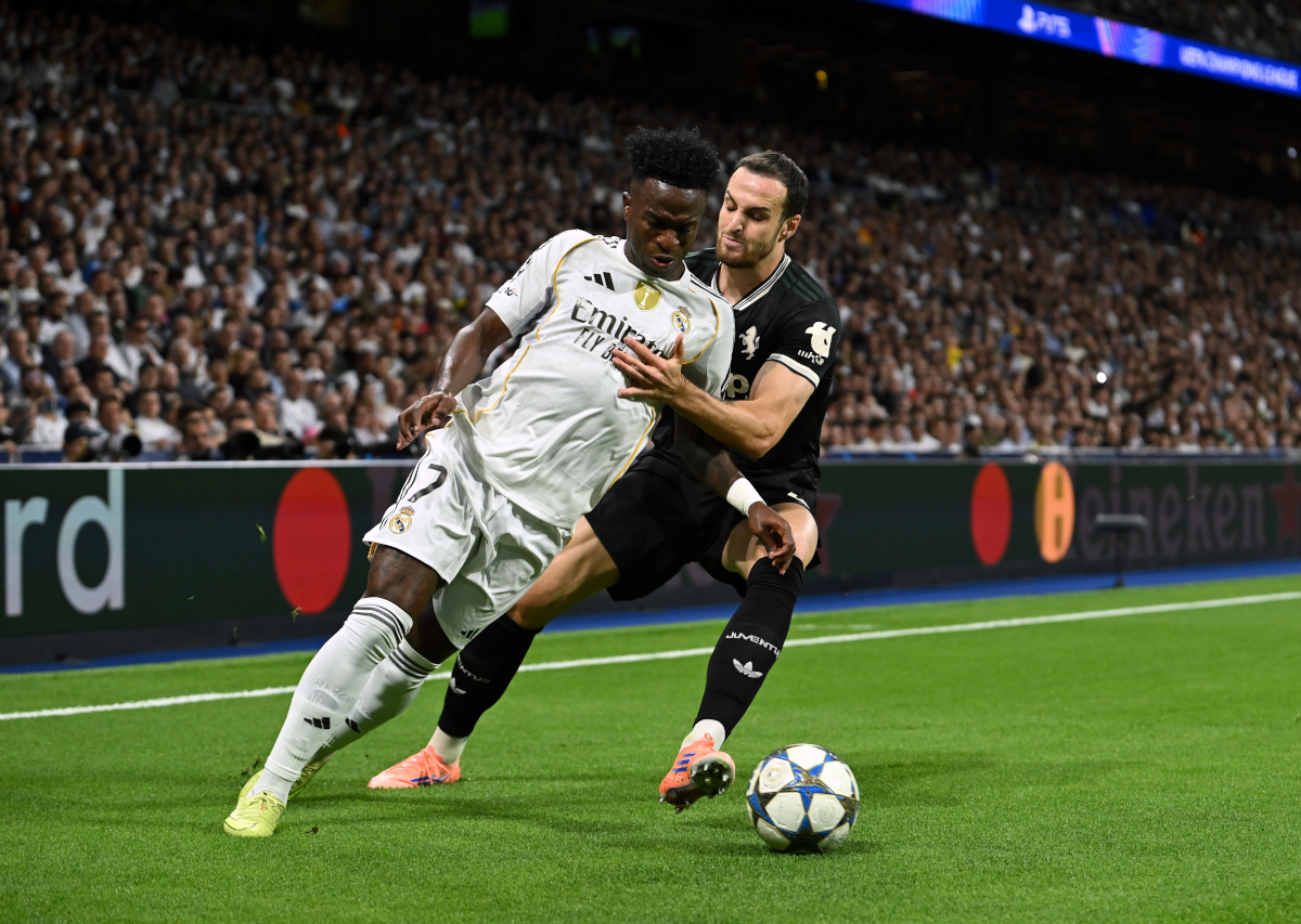MADRID, SPAIN - OCTOBER 22: Vinicius Junior of Real Madrid is challenged by Federico Gatti of Juventus during the UEFA Champions League 2025/26 League Phase MD3 match between Real Madrid C.F. and Juventus at Estadio Santiago Bernabeu on October 22, 2025 in Madrid, Spain. (Photo by Denis Doyle/Getty Images)