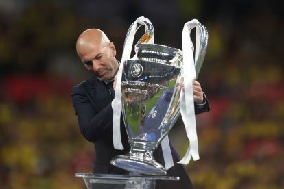 LONDON, ENGLAND - JUNE 01:Former Real Madrid and Juventus star Zinedine Zidane places the Champions League Trophy onto the plinth after the UEFA Champions League 2023/24 Final match between Borussia Dortmund and Real Madrid CF at Wembley Stadium on June 01, 2024 in London, England. (Photo by Lars Baron/Getty Images)