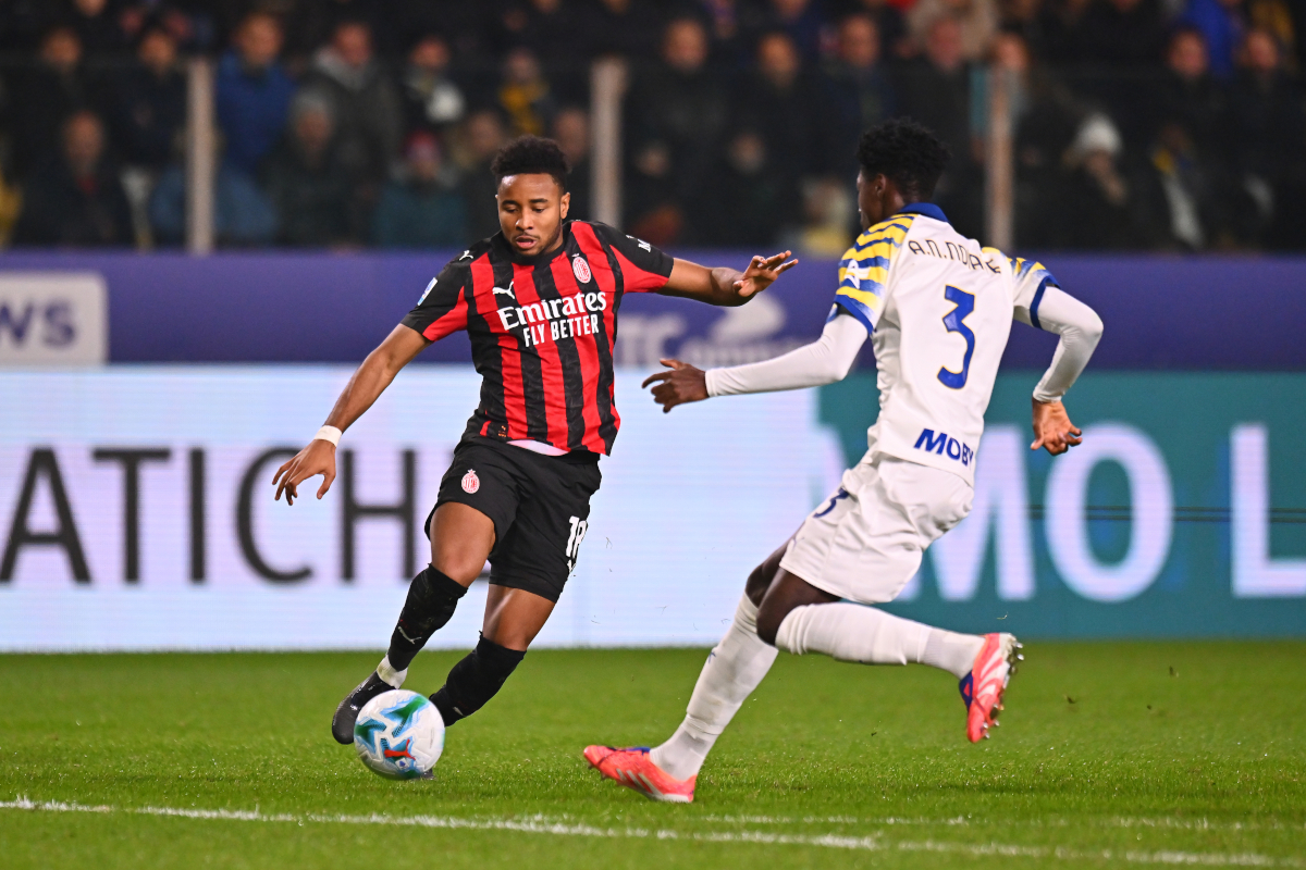 PARMA, ITALY - NOVEMBER 08: Christopher Nkunku of AC Milan runs with the ball whilst under pressure from Abdoulaye Ndiaye of Parma during the Serie A match between Parma Calcio 1913 and AC Milan at Stadio Ennio Tardini on November 08, 2025 in Parma, Italy. (Photo by Alessandro Sabattini/Getty Images)