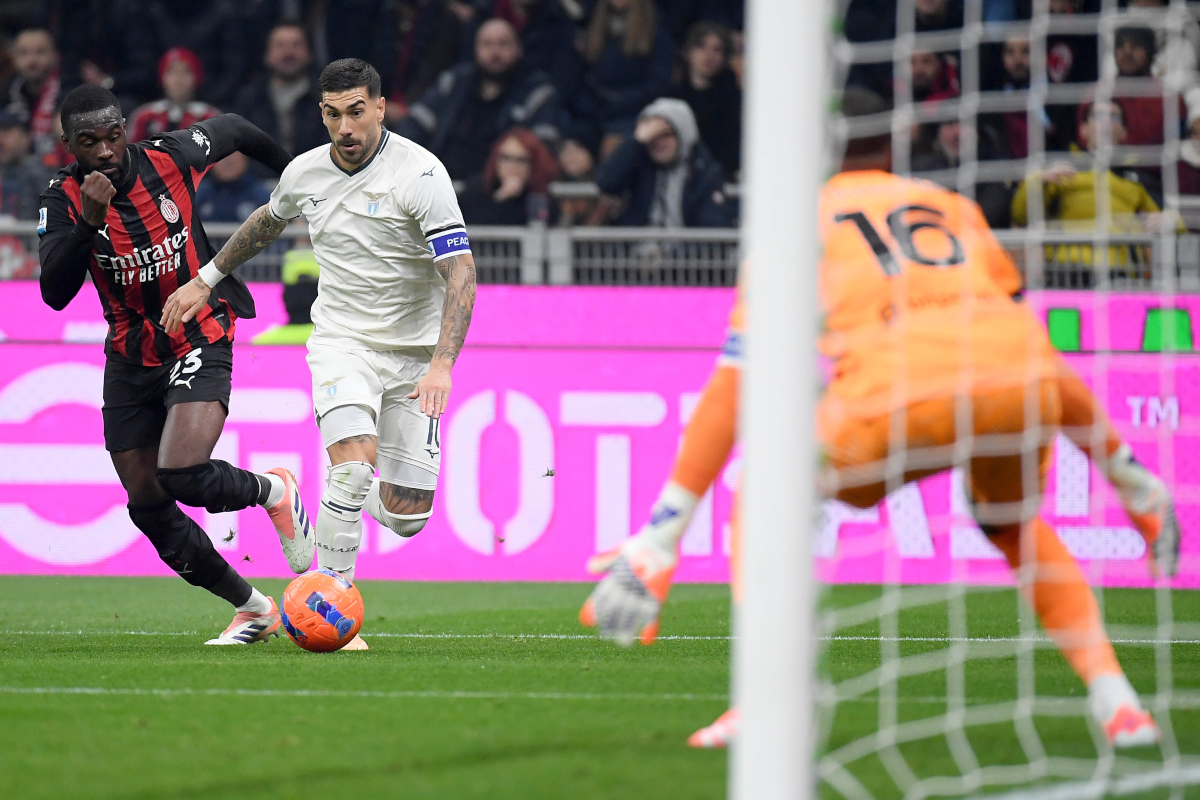 MILAN, ITALY - NOVEMBER 29: Mattia Zaccagni of SS Lazio compete for the ball with Fikayo Tomori of AC Milan during the Serie A match between AC Milan and SS Lazio at Giuseppe Meazza Stadium on November 29, 2025 in Milan, Italy. (Photo by Marco Rosi - SS Lazio/Getty Images)