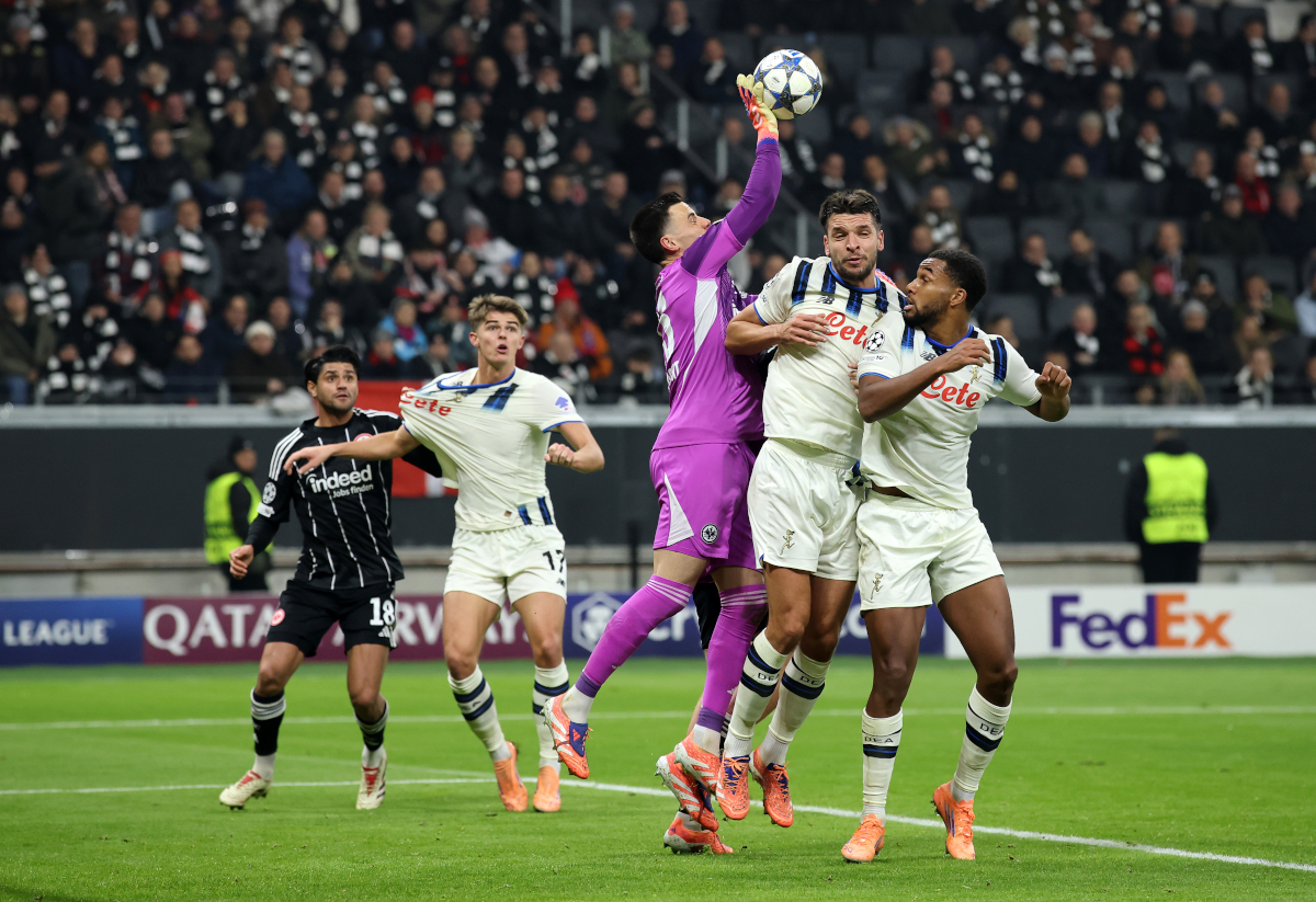 FRANKFURT AM MAIN, GERMANY - NOVEMBER 26: Michael Zetterer of Eintracht Frankfurt attempts to claim the ball whilst under pressure from Berat Djimsiti and Isak Hien of Atalanta BC during the UEFA Champions League 2025/26 League Phase MD5 match between Eintracht Frankfurt and Atalanta BC at Frankfurt Stadion on November 26, 2025 in Frankfurt am Main, Germany. (Photo by Alex Grimm/Getty Images)